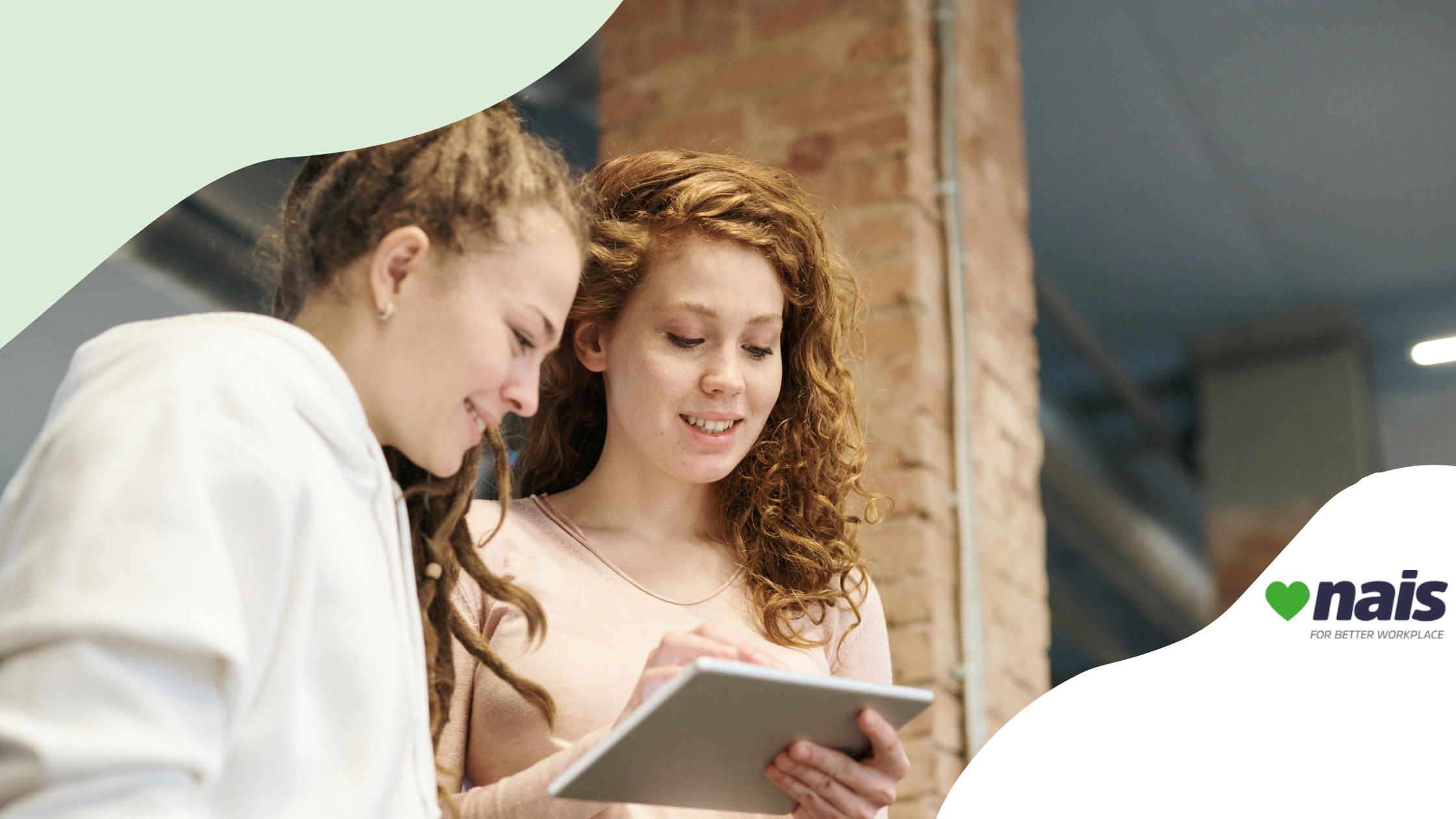 two women looking at an iPad smiling