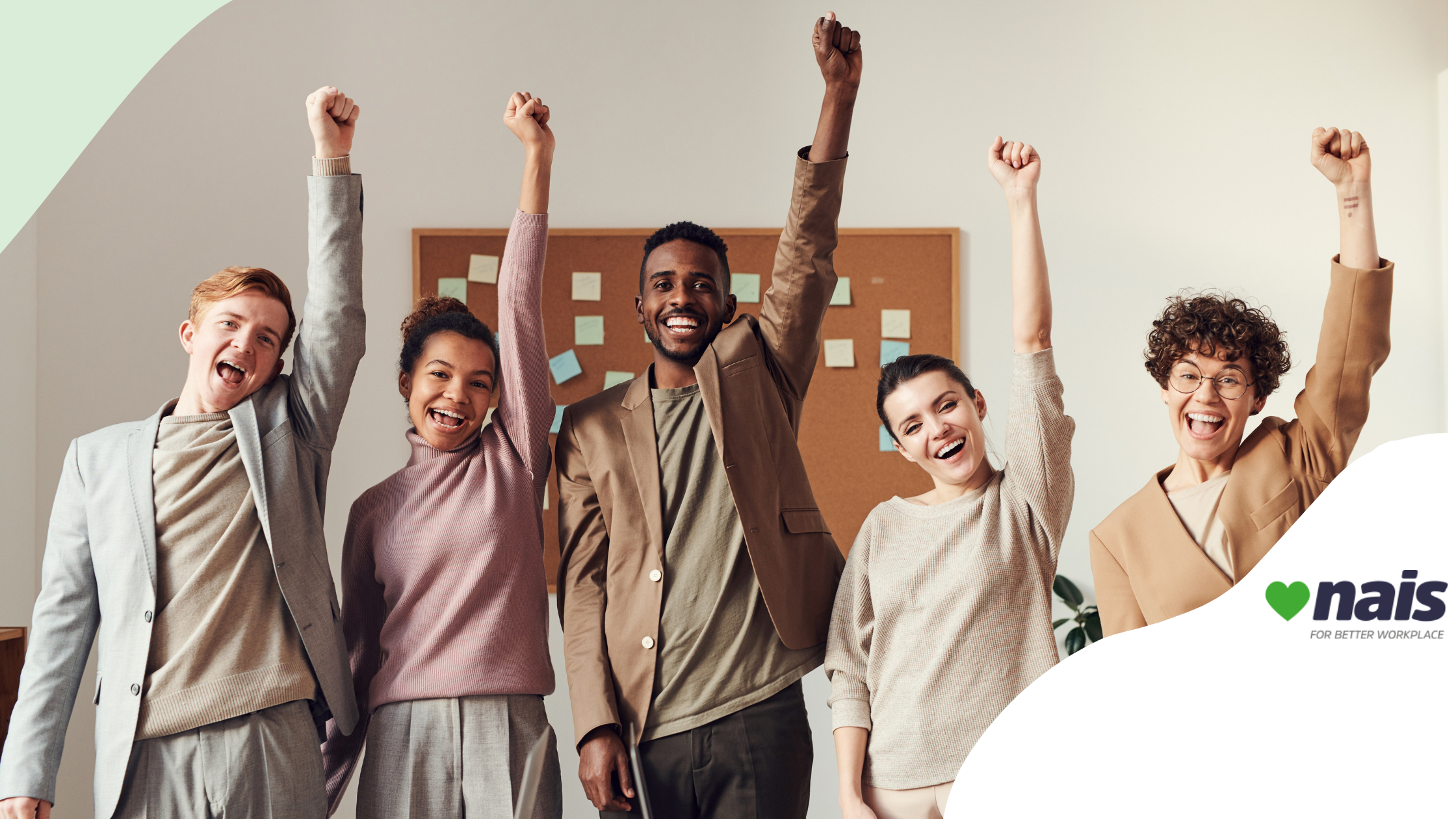 People raising their arms up in the air and smiling in an office