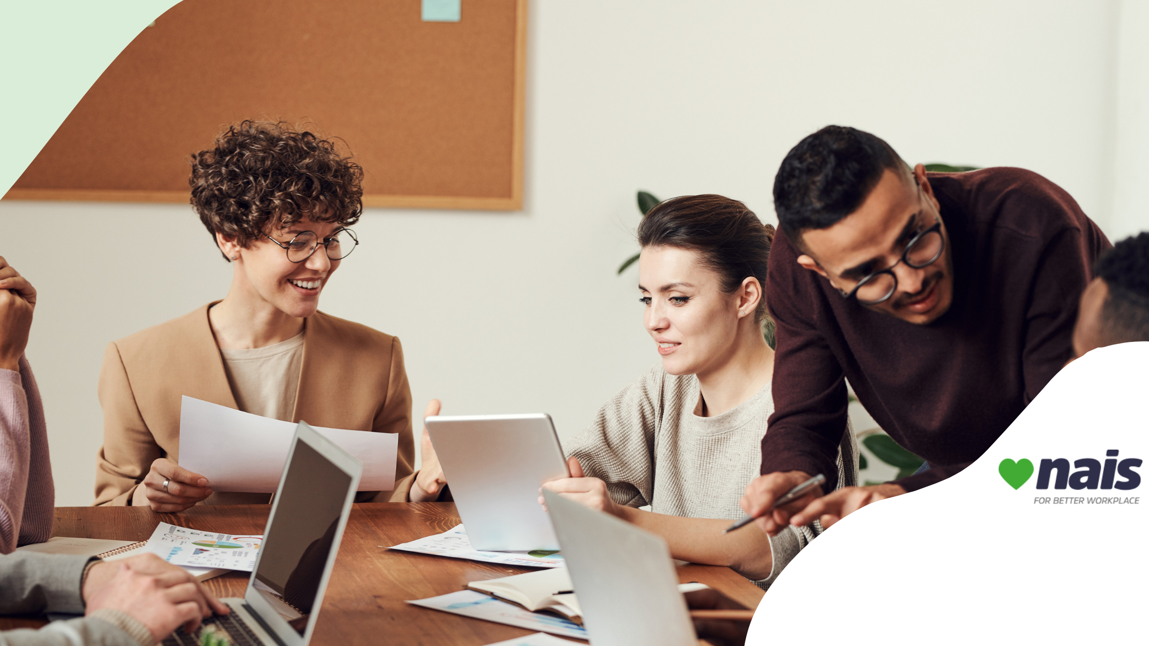 young employees smiling and working and talking by a desk