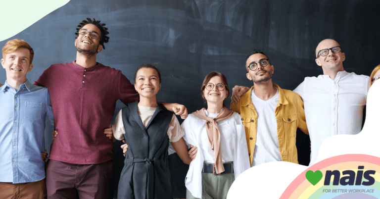 team of lgbtq employees smiling at camera supporting one another