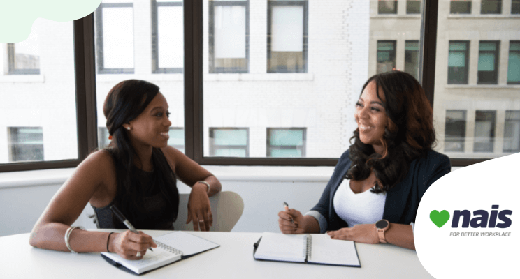 two women sitting and talking